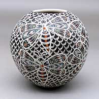 A polychrome jar decorated with a lightly carved, sgraffito and painted flying insect and geometric design
 by Ailadi Mijarez of Mata Ortiz and Casas Grandes