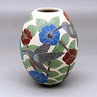 A polychrome jar decorated with a sgraffito and painted hummingbird, butterfly, flower, leaf and branch design
 by Karla Flores of Mata Ortiz and Casas Grandes