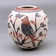 A polychrome jar decorated with a slipped and sgraffito bird, branch, leaf, berry and geometric design
 by Lupita Quezada of Mata Ortiz and Casas Grandes