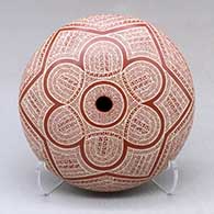 A red on tan seed pot decorated with a sgraffito fineline and geometric design above the shoulder
 by Jazmin Ramirez of Mata Ortiz and Casas Grandes