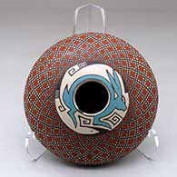 A polychrome seed pot decorated above the shoulder with a checkerboard, rabbit and geometric design
 by Julio Mora of Mata Ortiz and Casas Grandes