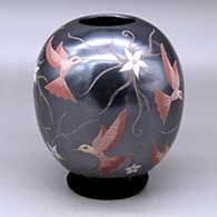 A polychrome jar decorated with a sgraffito and painted hummingbird, flower and vine design
 by Elicena Cota of Mata Ortiz and Casas Grandes
