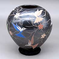 A polychrome jar decorated with a sgraffito and painted hummingbird, flower and vine design
 by Elicena Cota of Mata Ortiz and Casas Grandes