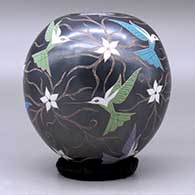 A polychrome jar decorated with a sgraffito and painted hummingbird, flower and vine design, click or tap to see a larger version