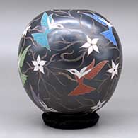A polychrome jar decorated with a sgraffito and painted hummingbird, flower and vine design, click or tap to see a larger version
