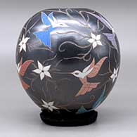 A polychrome jar decorated with a sgraffito and painted hummingbird, flower and vine design, click or tap to see a larger version