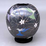 A polychrome jar decorated with a sgraffito and painted hummingbird, flower and vine design
 by Elicena Cota of Mata Ortiz and Casas Grandes