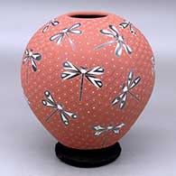 A polychrome jar decorated with a sgraffito and painted dragonfly and geometric mesh design
 by Elicena Cota of Mata Ortiz and Casas Grandes