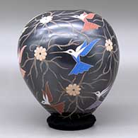 A polychrome jar decorated with a sgraffito and painted hummingbird, flower and vine design, click or tap to see a larger version