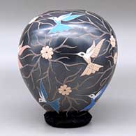 A polychrome jar decorated with a sgraffito and painted hummingbird, flower and vine design, click or tap to see a larger version