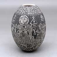 A black on white jar decorated with a sgraffito Native Americans on the Night of the Dead at the Cemetery and geometric design
 by Hector Javier Martinez of Mata Ortiz and Casas Grandes