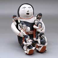 A sitting grandmother storyteller figure holding 10 children
 by Frances Herrera of Cochiti