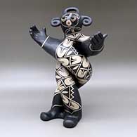 A polychrome mudhead figure all twisted up and holding his arms out, and decorated with a geometric design
 by Lisa Holt of Cochiti