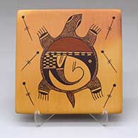 A polychrome tile decorated with a turtle, dragonfly, bird element and geometric design, plus fire clouds
 by Garrett Maho of Hopi