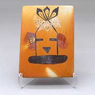 A polychrome tile decorated with a katsina design and fire clouds
 by Patricia Honie of Hopi