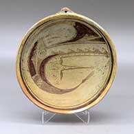 A polychrome open bowl with a hanging nub on the shoulder and a bird-hanging-from-sky-band and geometric design inside
 by Nampeyo of Hano of Hopi