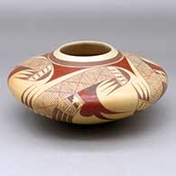 A polychrome seed pot decorated with a four panel bird element, migration pattern and geometric design
 by Jeremy Adams of Hopi