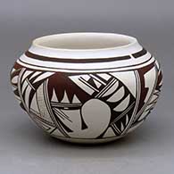 A polychrome white-ware bowl decorated with a four panel bird element and geometric design plus fire clouds
 by Grace Navasie of Hopi
