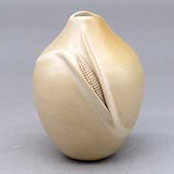 A polished buff jar with an organic opening and an ear of corn applique
 by Iris Nampeyo of Hopi