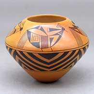 A small polychrome jar decorated with fire clouds and a four panel bird element and geometric design
 by Garrett Maho of Hopi