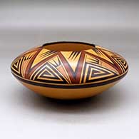 A polychrome seed pot decorated with fire clouds and an eight panel bat wing, angular spiral and geometric design
 by Garrett Maho of Hopi