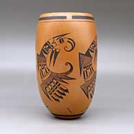 A black on red cylinder decorated with a four panel bird element, tadpole and geometric design, click or tap to see a larger version