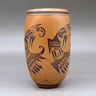 A black on red cylinder decorated with a four panel bird element, tadpole and geometric design, click or tap to see a larger version