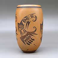 A black on red cylinder decorated with a four panel bird element, tadpole and geometric design, click or tap to see a larger version