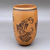A black on red cylinder decorated with a four panel bird element, tadpole and geometric design
 by Fawn Navasie of Hopi