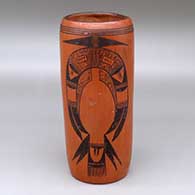 A black on red cylinder decorated with a two panel bird element and geometric design
 by Unknown of Hopi
