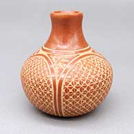 Small red jar with a slightly flared opening and a sgraffito kiva step, feather, and geometric design
 by Wilma Baca Tosa of Jemez