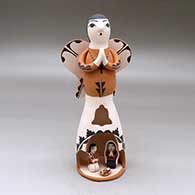 A standing Singing Angel figure with a nativity scene in a cutout in her skirt
 by Angel Bailon of Jemez