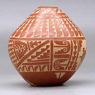 A red seed pot decorated with a sgraffito turtle, corn plant, feather, arrowhead and geometric design, click or tap to see a larger version