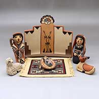 A six-piece Nativity set with a carpet
 by Linda Lucero Fragua of Jemez