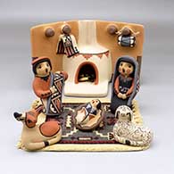 A seven piece Jemez style nativity set with a kiva fireplace and carpet
 by Linda Lucero Fragua of Jemez