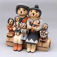 A grandparent storyteller figure with three children
 by Chrislyn Fragua of Jemez
