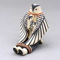 A sitting eagle storyteller with two chicks
 by Loren Wallowing Bull of Jemez