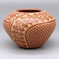 A red on buff jar decorated with a sgraffito snowflake, kiva step and geometric design
 by Wilma Baca Tosa of Jemez