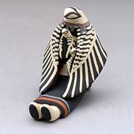 A sitting eagle storyteller with two chicks
 by Loren Wallowing Bull of Jemez