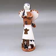 A standing Singing Angel figure with a nativity in her skirt
 by Angel Bailon of Jemez