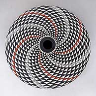 A polychrome seed pot decorated with a spiral mesa geometric design
 by Robert Kasero Sr of Laguna