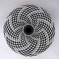 A black on white seed pot decorated with a spiral mesa geometric design
 by Robert Kasero Sr of Laguna