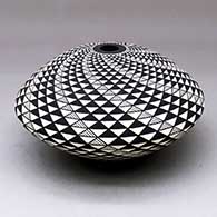 A black on white seed pot decorated with a spiral mesa geometric design
 by Robert Kasero Sr of Laguna