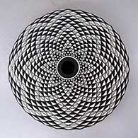 A black on white seed pot decorated with a spiral mesa geometric design
 by Robert Kasero Sr of Laguna