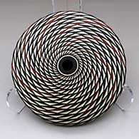 A polychrome seed pot decorated with a spiral mesa geometric design
 by Robert Kasero Sr of Laguna