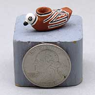 A miniature polychrome duck effigy pot decorated with a geometric design
 by Thomas Natseway of Laguna