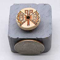 A miniature polychrome flat top seed pot decorated on top with a butterfly design
 by Thomas Natseway of Laguna