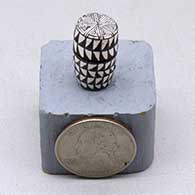 A miniature black on white lidded jar decorated with a fineline and geometric design
 by Thomas Natseway of Laguna