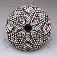 A polychrome seed pot decorated with a spiral mesa geometric design top and bottom
 by Robert Kasero Sr of Laguna