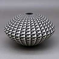 A black on white seed pot decorated with a spiral mesa geometric design
 by Robert Kasero Sr of Laguna